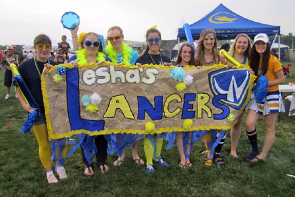 Students pose with banner that reads &quot;Lesha&#039;s Lancers.&quot;