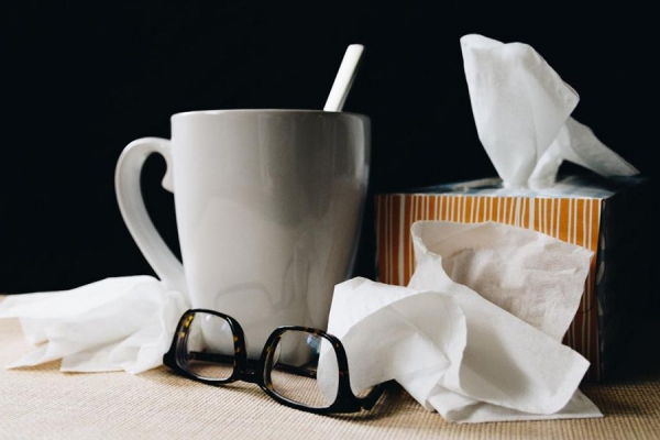 coffee cup and box of facial tissues