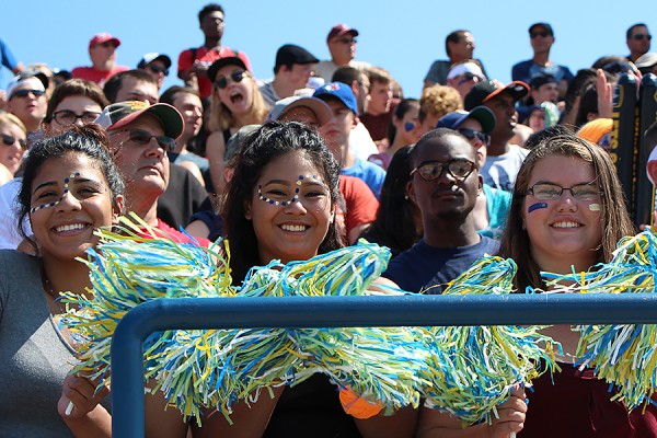 Lancer fans waving pompons in stadium stands.