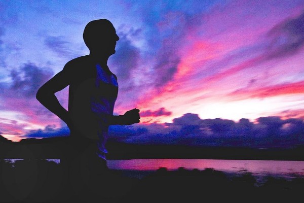 runner silhouetted against sky