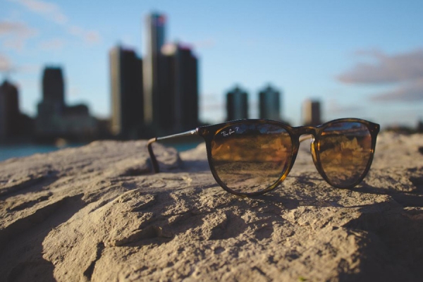 sunglasses in front of Detroit skyline