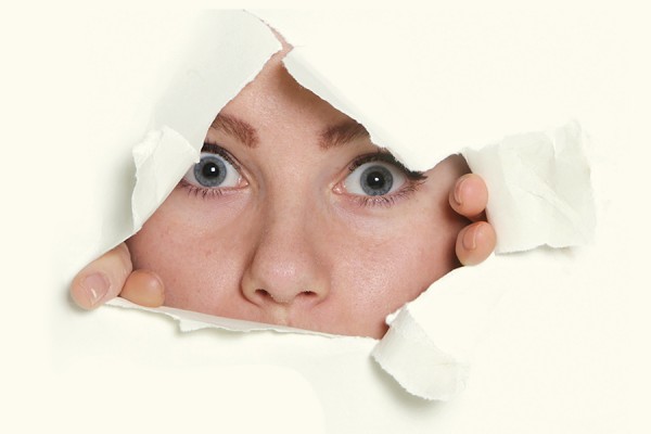 UWill Discover image - woman breaking through sheet of paper