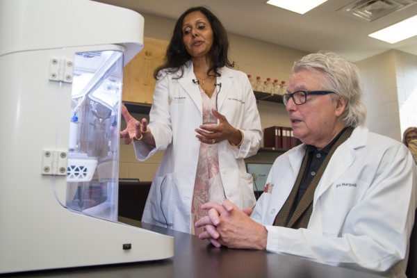 Dr. Charu Chandrasekera, Executive Director of the Canadian Centre for Alternatives to Animal Methods (CCAAM), explains to Eric Margolis how the lab utilizes 3D printing to produce replicas of human tissues and organs for research during CCAAM&#039;s grand ope