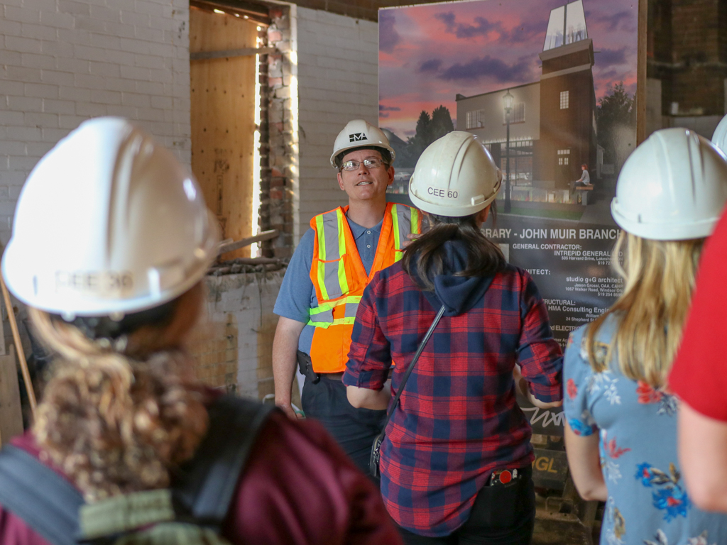 UWindsor civil engineering sessional instructor William Tape leads fourth-year students through the construction site of the Windsor Public Library Sandwich branch on Aug. 3, 2018.