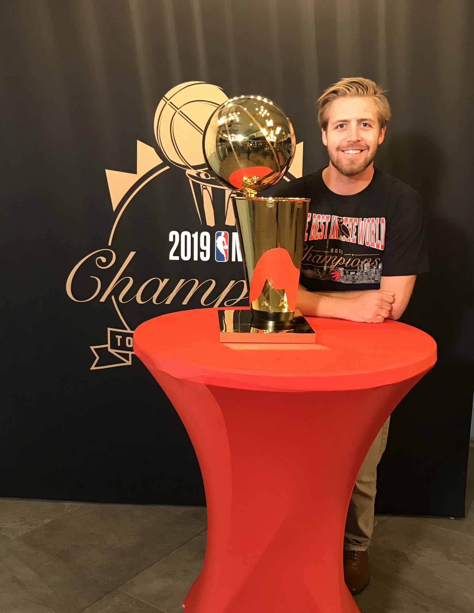 a person standing next to a trophy