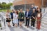 A group poses for a ribbon cutting