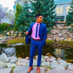 student in front of garden