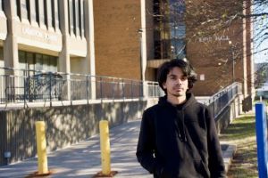 Student Representative standing in front of building