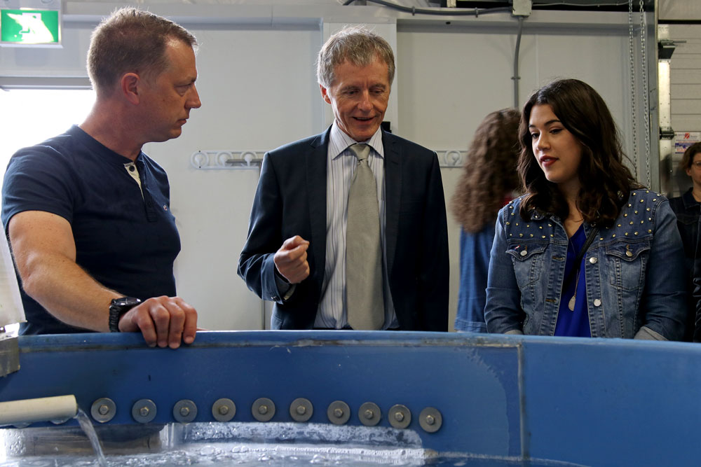 Dr. Trevor Pitcher, Dr. Alan Wildeman and University of Windsor graduate Tina Suntres examine a tank housing the invasive sea lamprey at the grand opening of the Freshwater Restoration Ecology Centre.