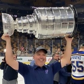 UWindsor grad Michael Murphy, chiropractor for the St. Louis Blues, hoists the Stanley Cup after the team won its first-ever NHL title.
